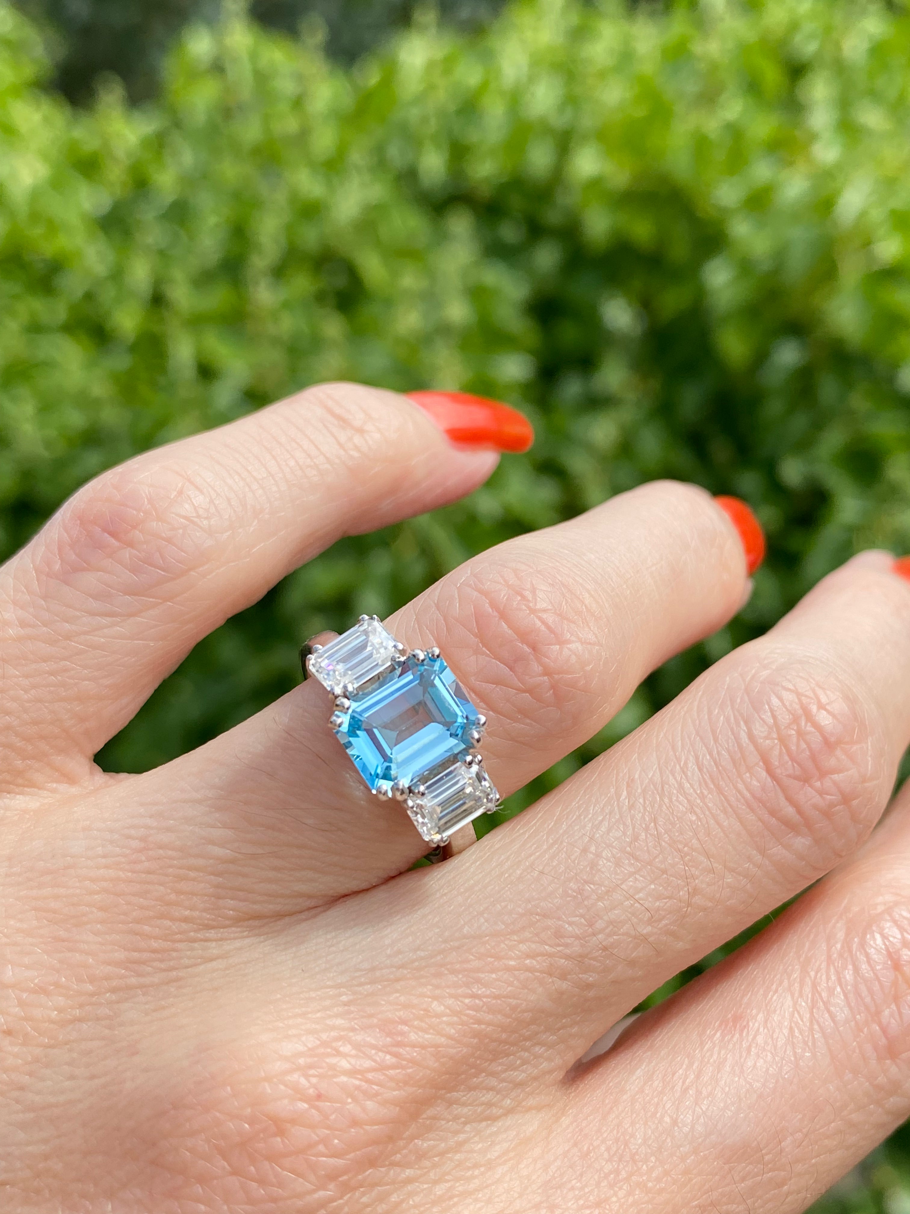 3.50 CTW Emerald Cut Blue Topaz and Moissanite Three Stone Ring in Sterling Silver