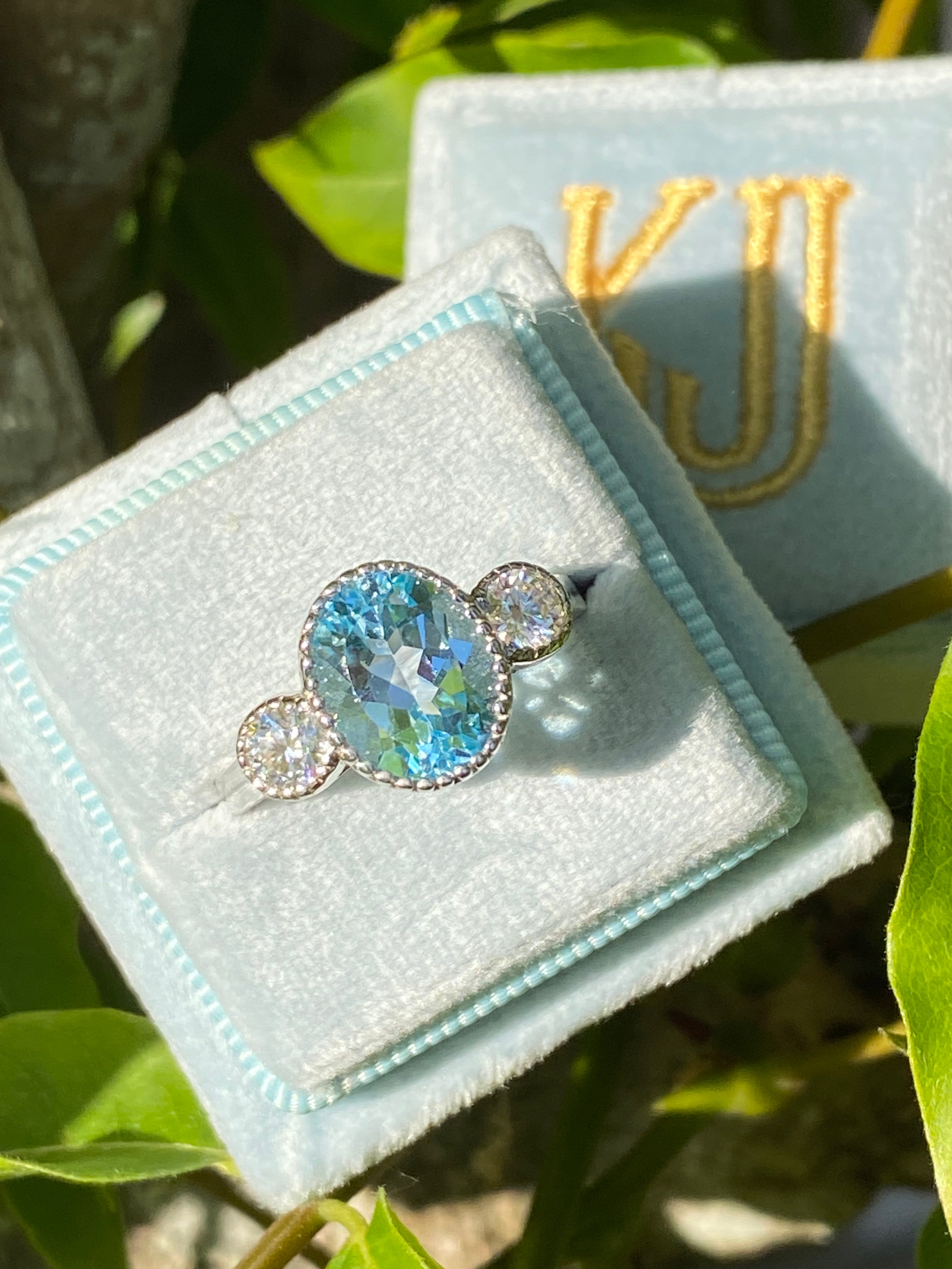 3.34 Carat Oval Cut Blue Topaz and Moissanite Three Stone Ring in Sterling Silver