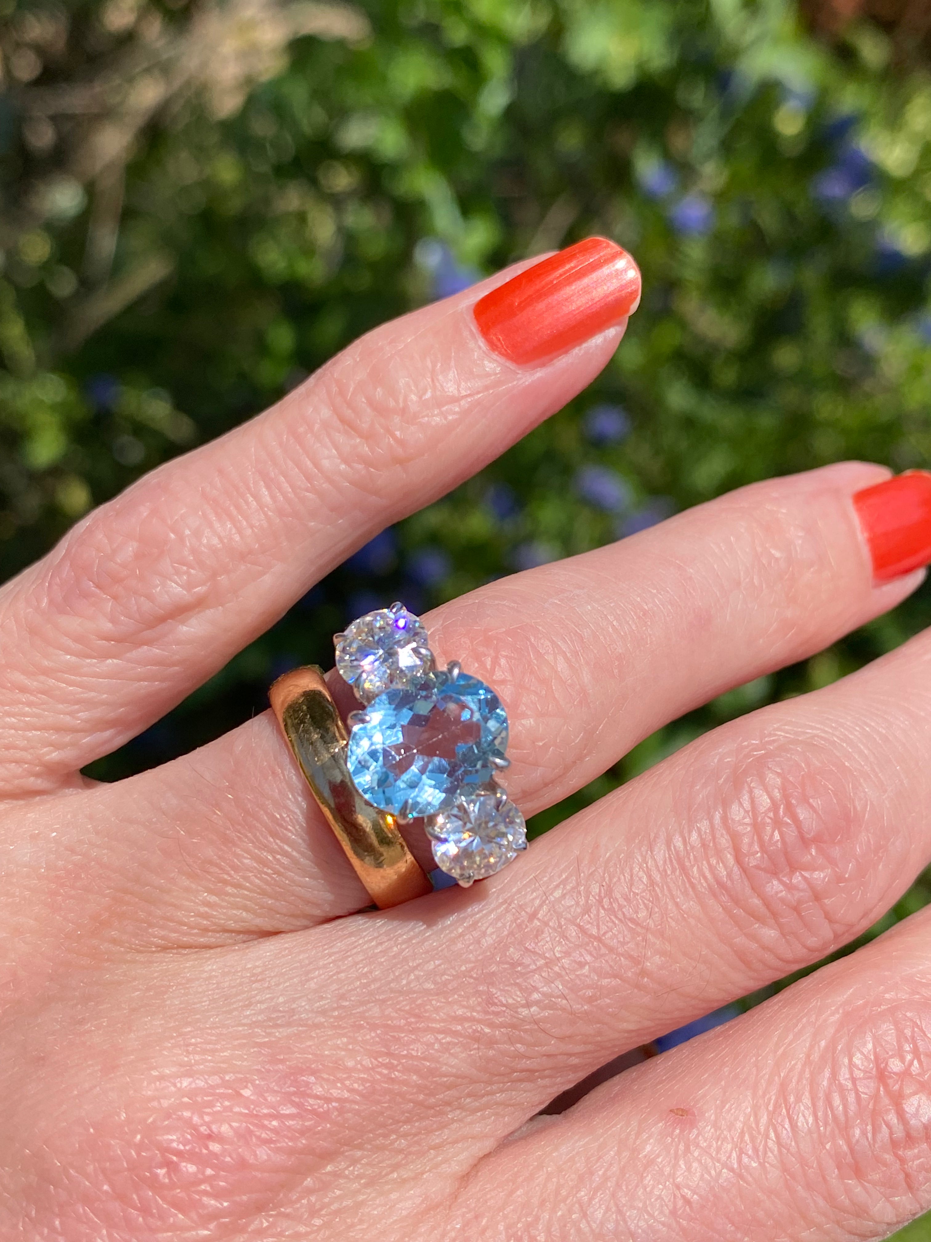3.99 Carat Oval Cut Blue Topaz and 1.85 Carat Moissanite Three Stone Ring in Sterling Silver