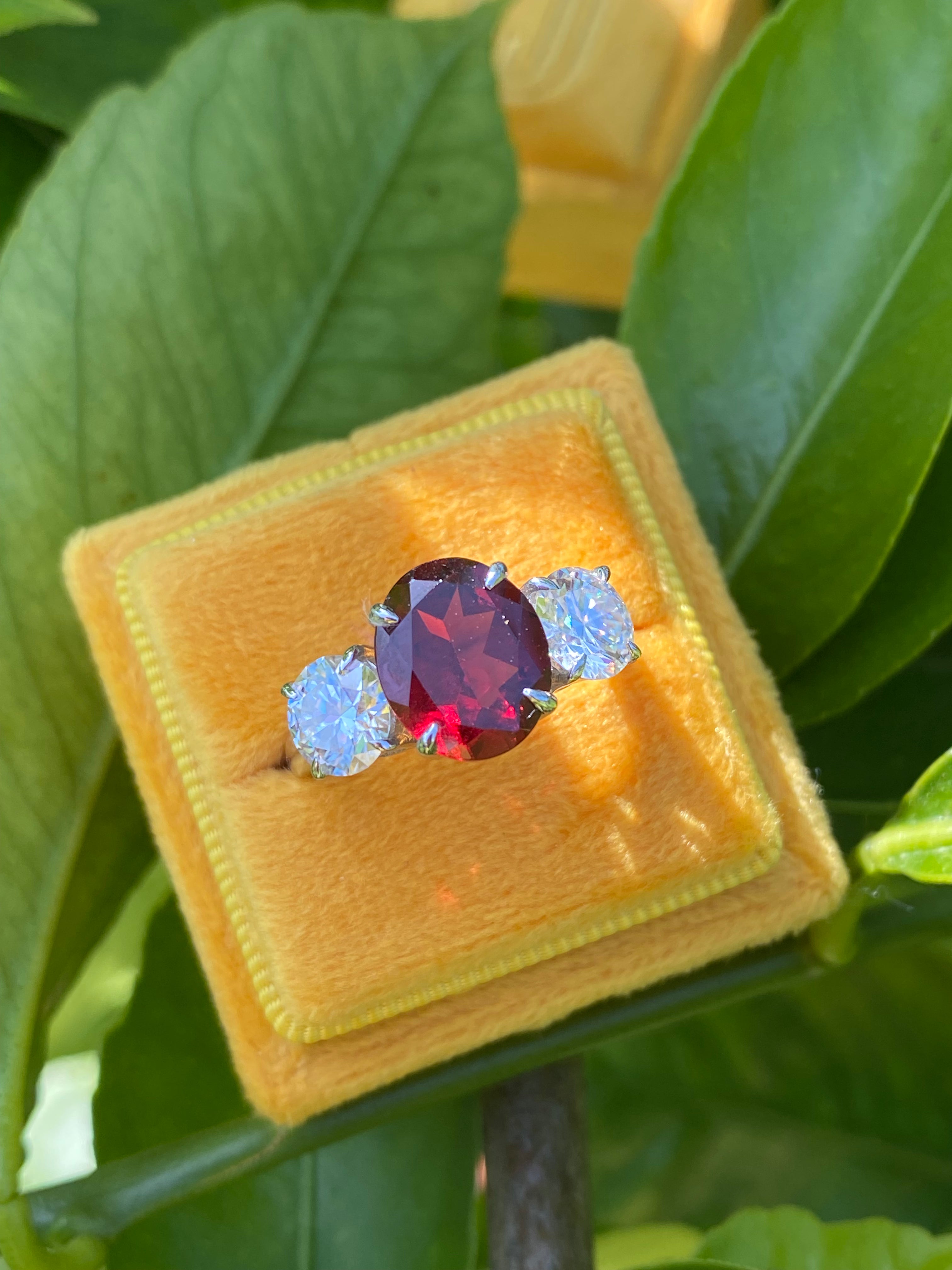 4.10 Carat Oval Cut Garnet and 1.85 Carat Moissanite Three Stone Ring in Sterling Silver