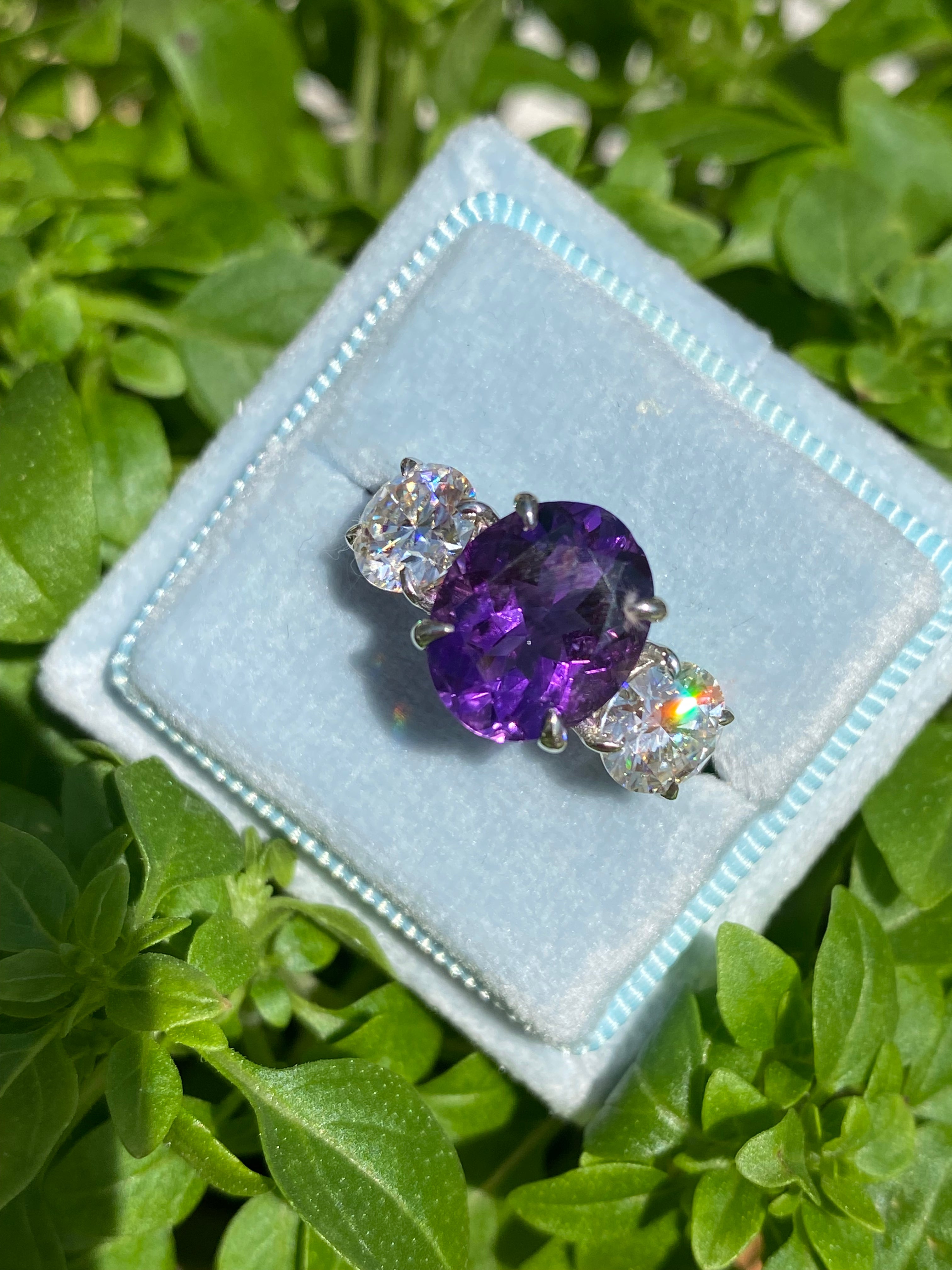 3.42 Carat Oval Cut Amethyst and 1.85 Carat Moissanite Three Stone Ring in Sterling Silver