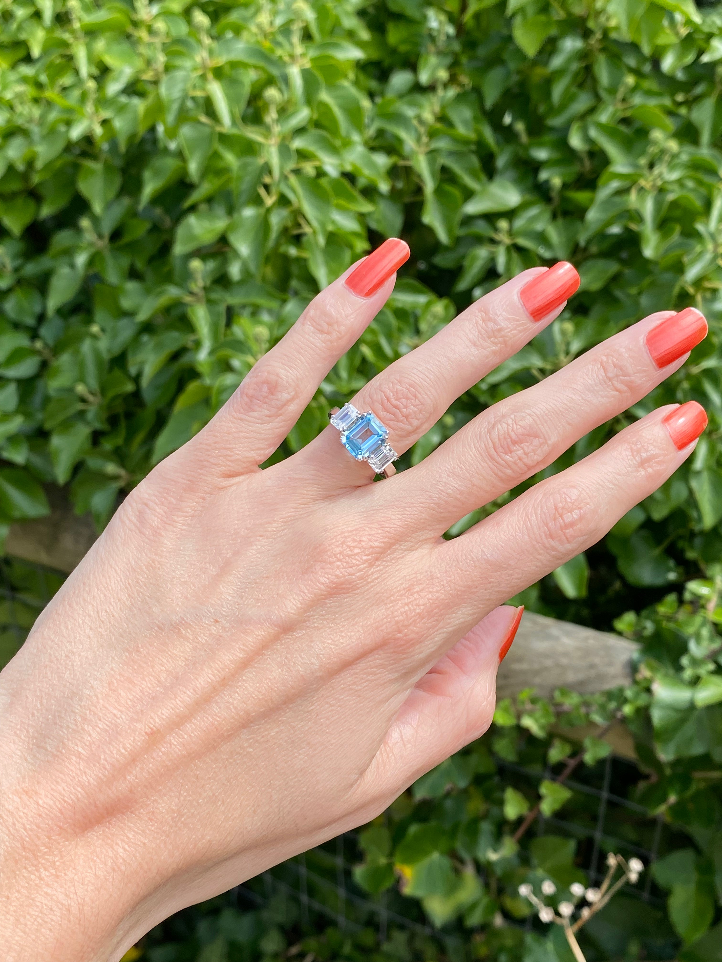 3.50 CTW Emerald Cut Blue Topaz and Moissanite Three Stone Ring in Sterling Silver