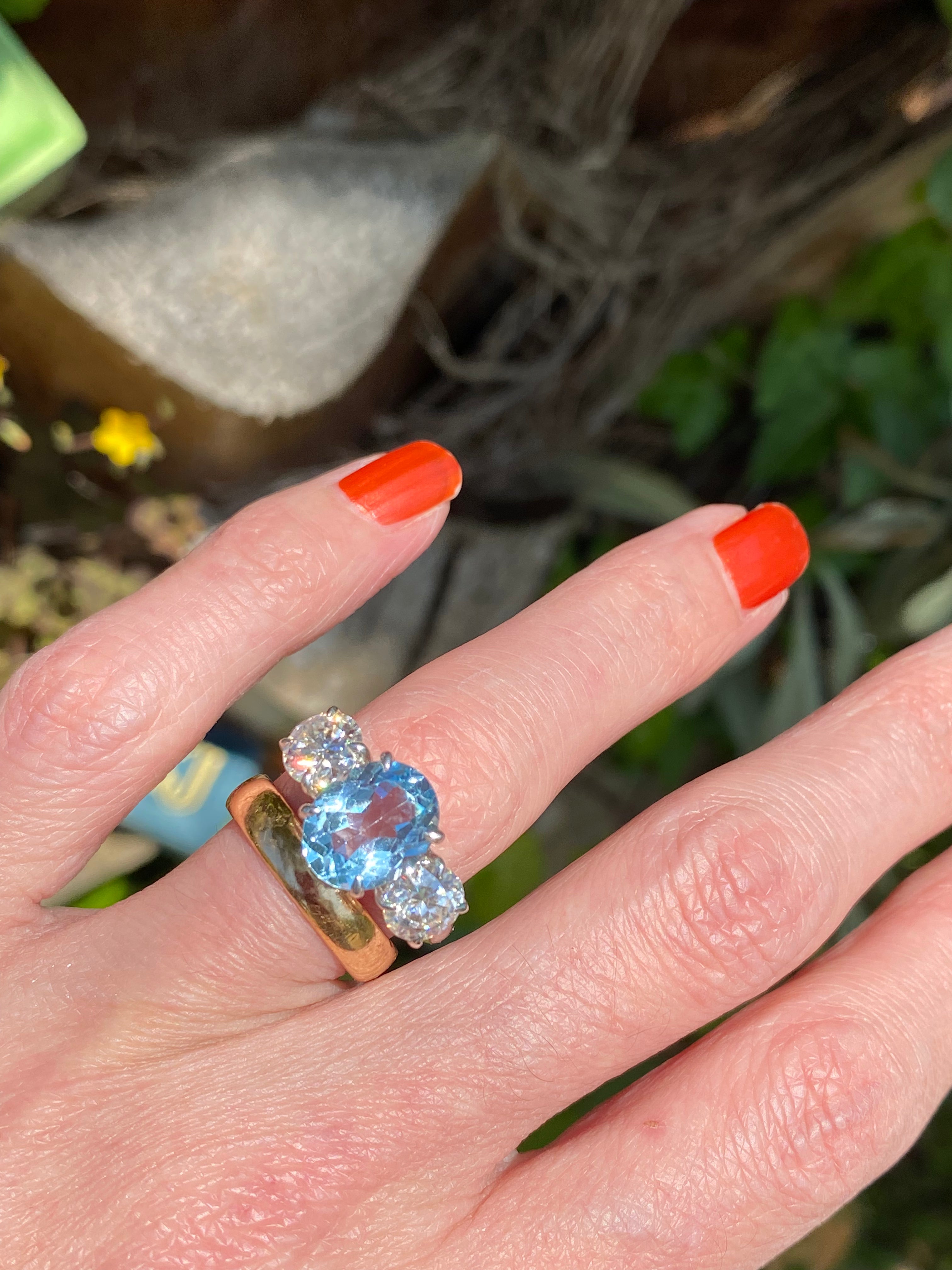3.99 Carat Oval Cut Blue Topaz and 1.85 Carat Moissanite Three Stone Ring in Sterling Silver