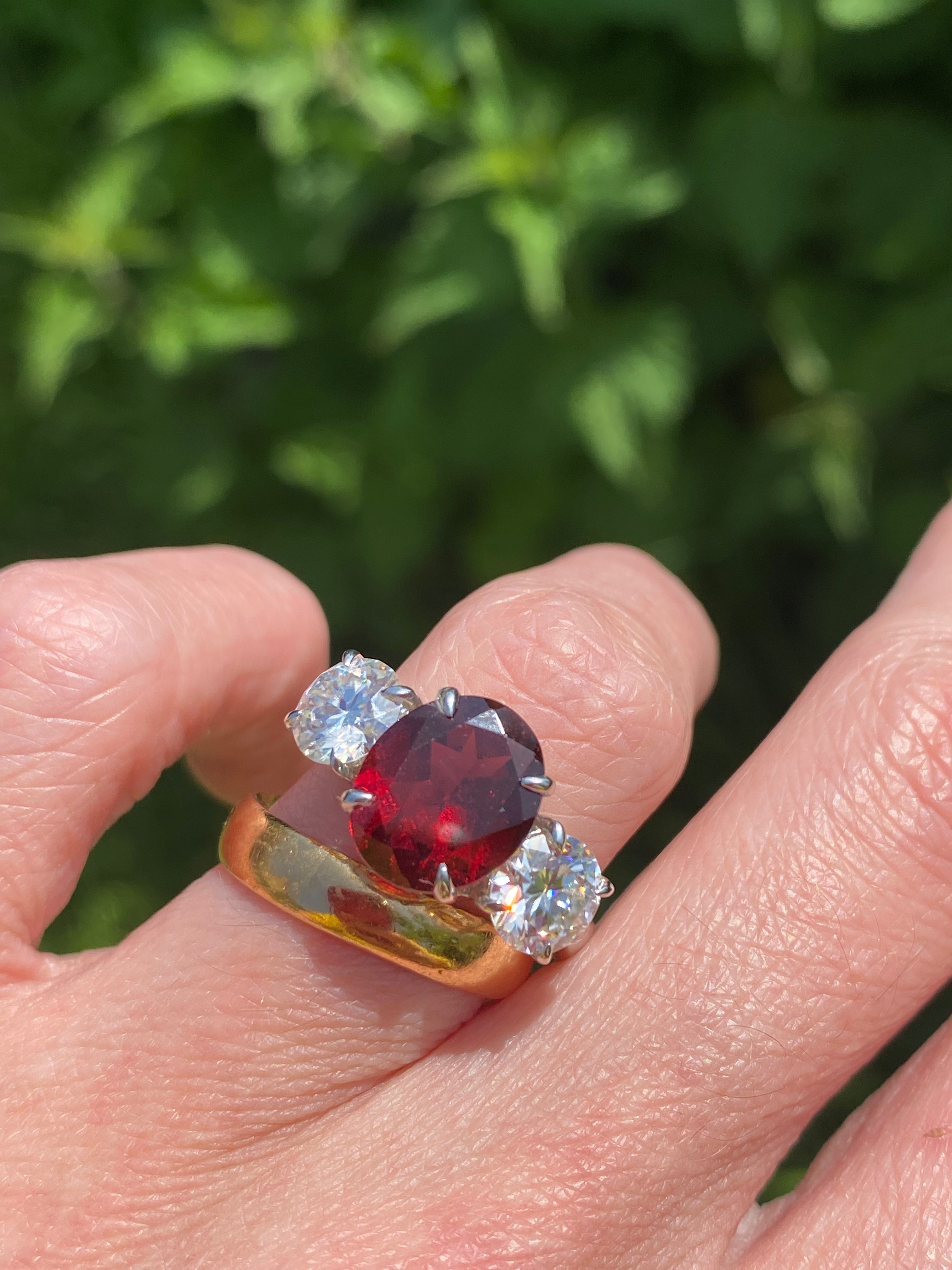 4.10 Carat Oval Cut Garnet and 1.85 Carat Moissanite Three Stone Ring in Sterling Silver