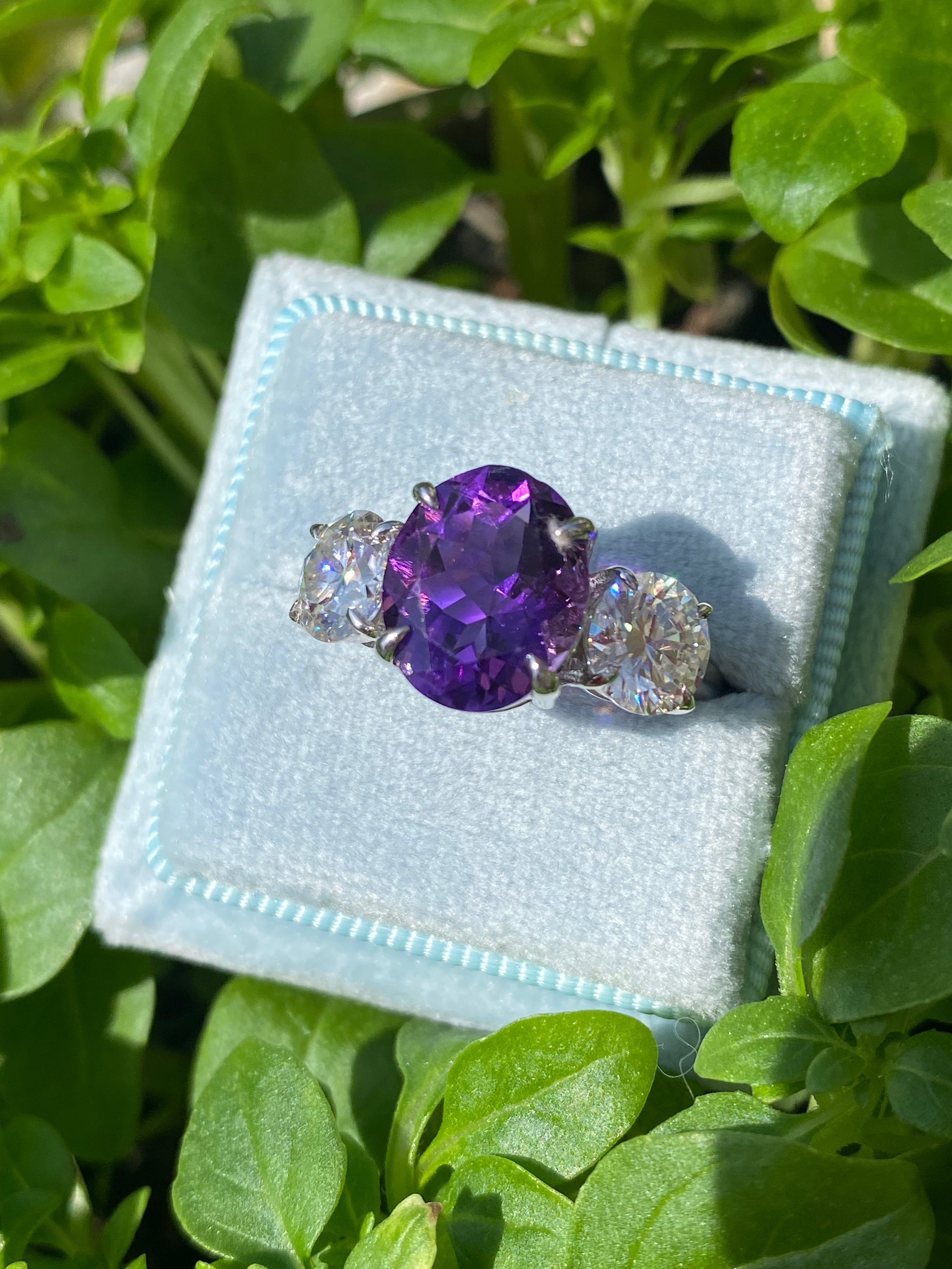 3.42 Carat Oval Cut Amethyst and 1.85 Carat Moissanite Three Stone Ring in Sterling Silver