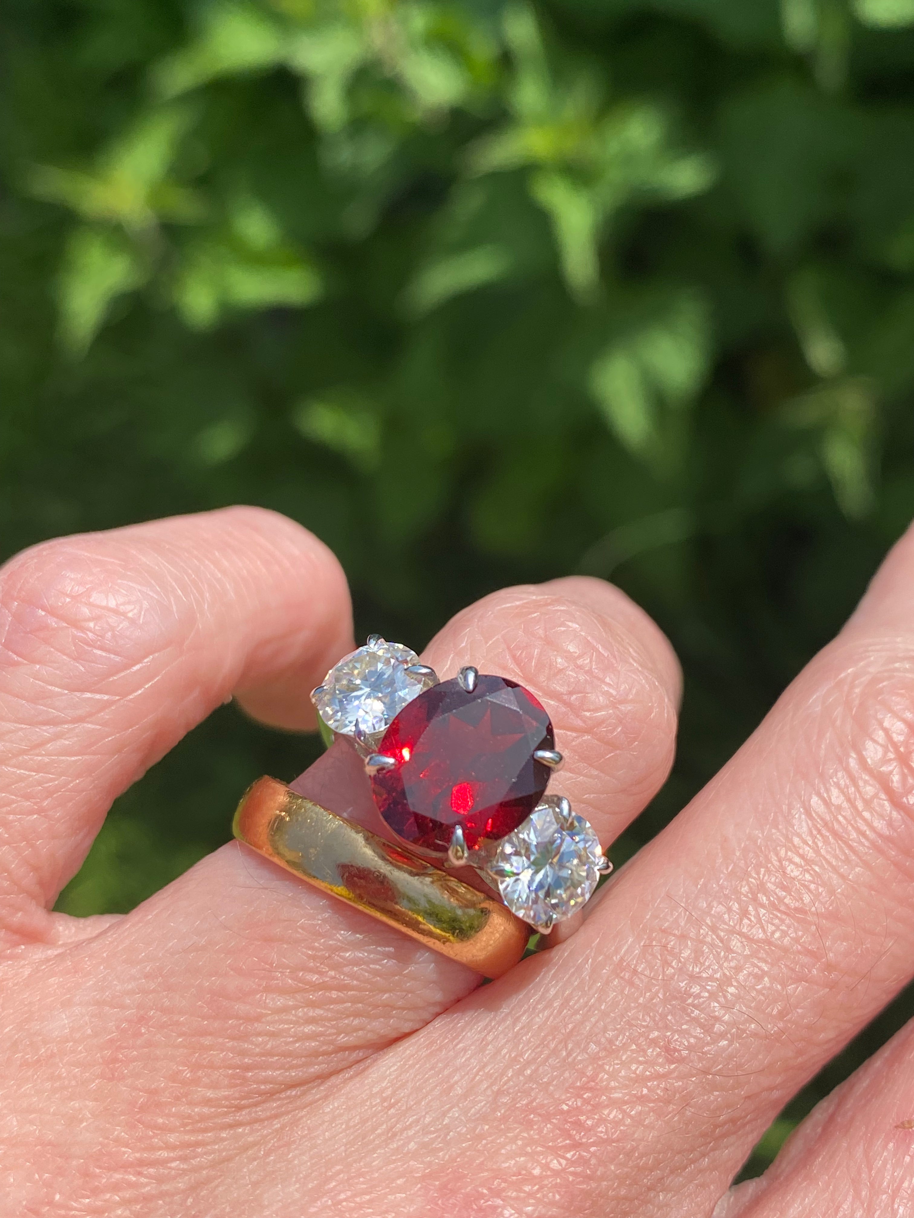 4.10 Carat Oval Cut Garnet and 1.85 Carat Moissanite Three Stone Ring in Sterling Silver