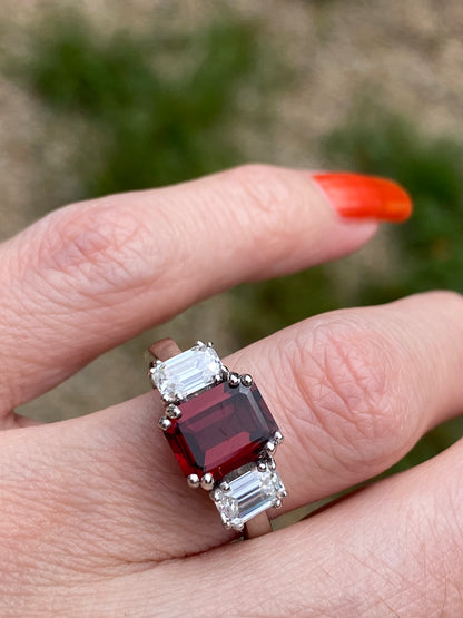 3.50 CTW Emerald Cut Garnet and Moissanite Three Stone Ring in Sterling Silver