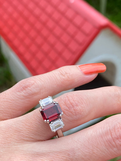 3.50 CTW Emerald Cut Garnet and Moissanite Three Stone Ring in Sterling Silver