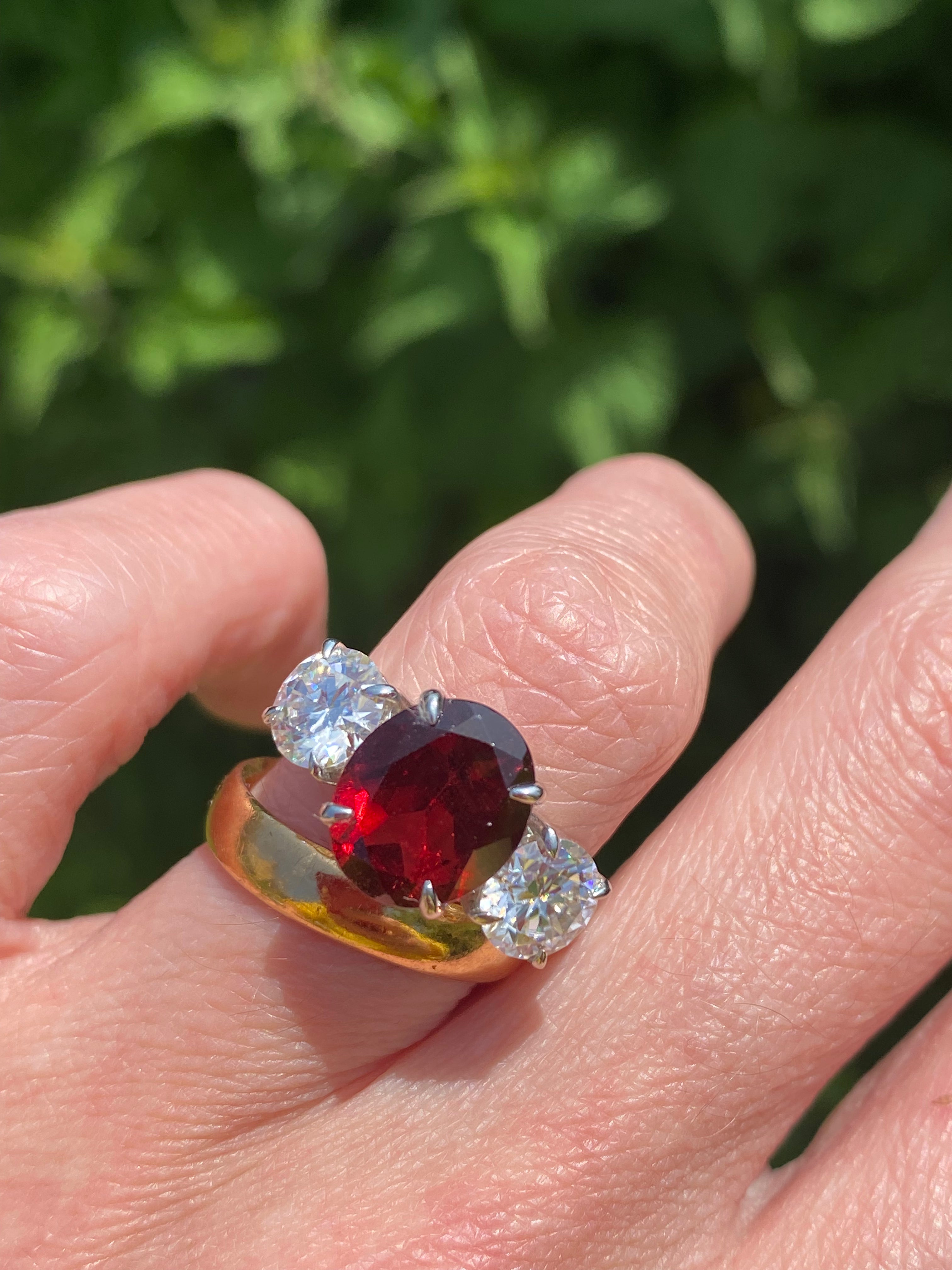4.10 Carat Oval Cut Garnet and 1.85 Carat Moissanite Three Stone Ring in Sterling Silver