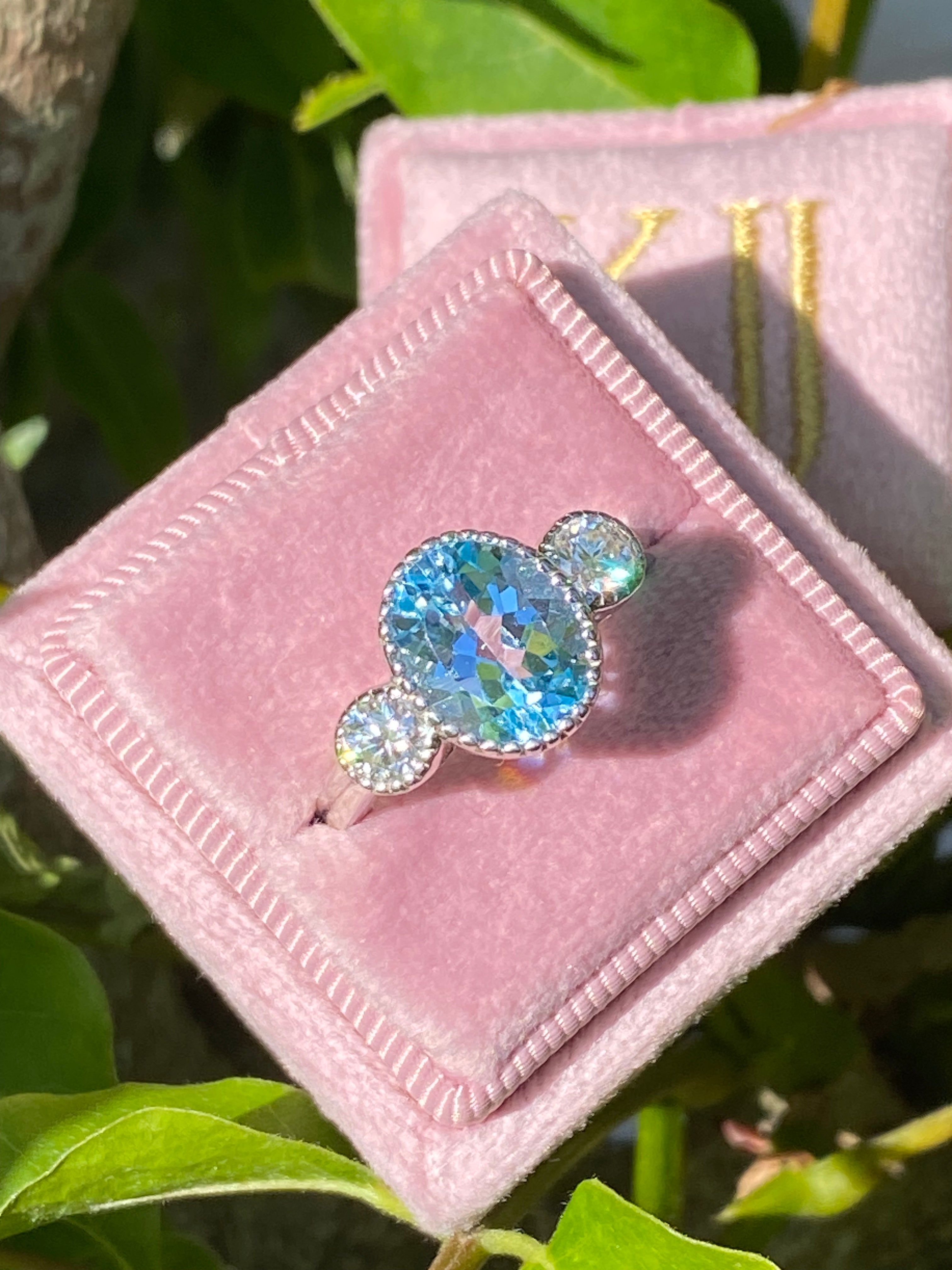 3.34 Carat Oval Cut Blue Topaz and Moissanite Three Stone Ring in Sterling Silver