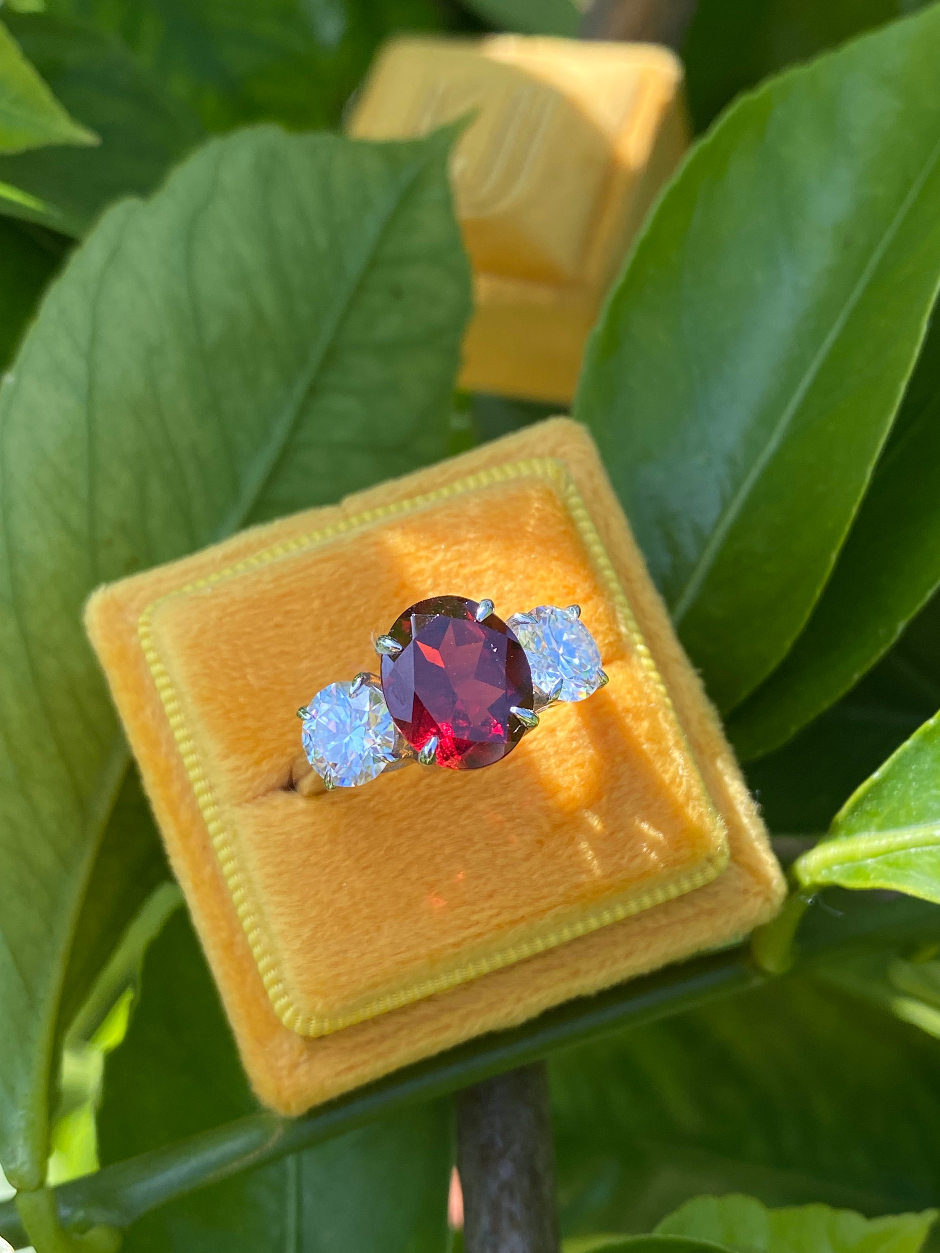 4.10 Carat Oval Cut Garnet and 1.85 Carat Moissanite Three Stone Ring in Sterling Silver