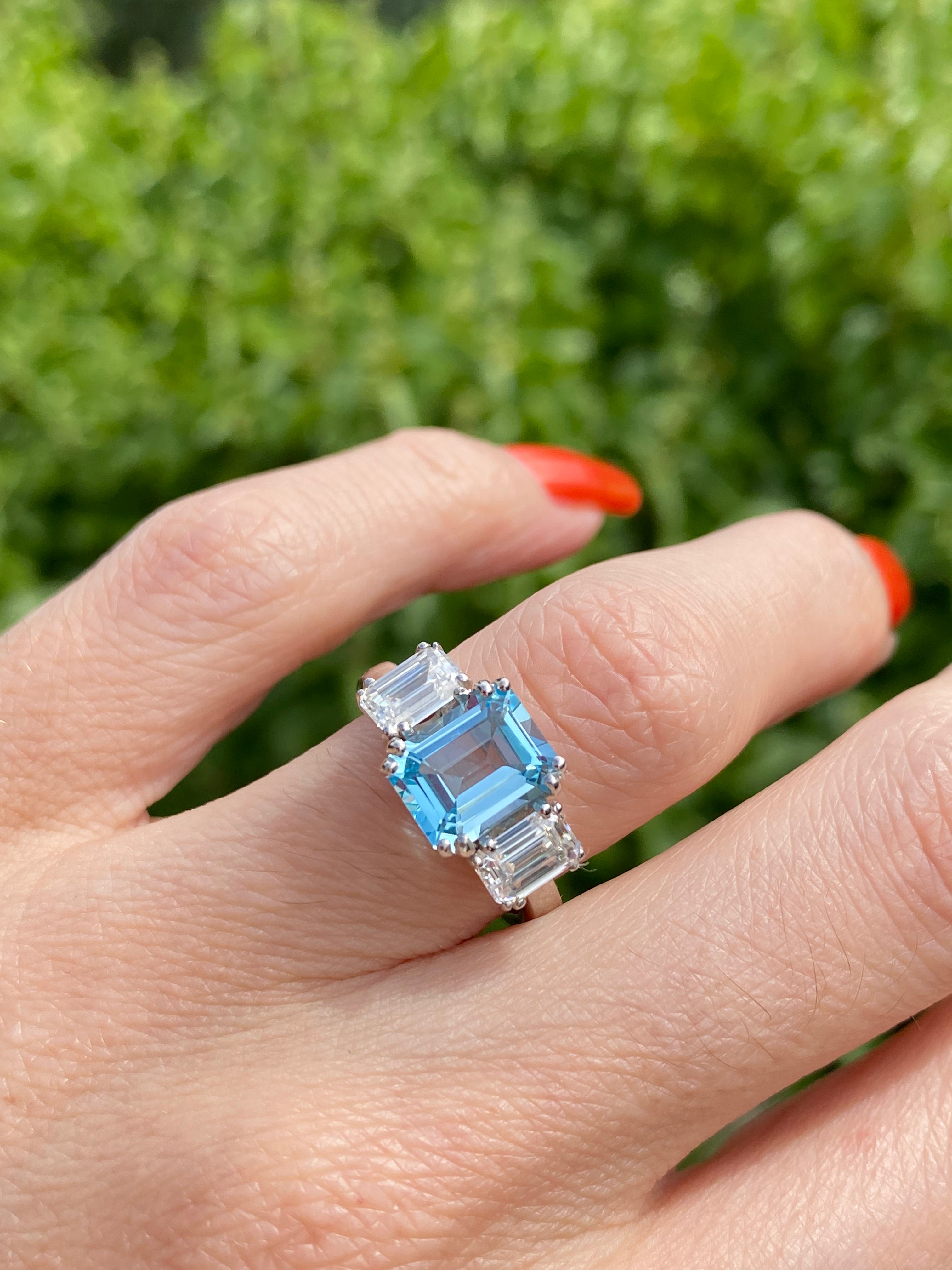 3.50 CTW Emerald Cut Blue Topaz and Moissanite Three Stone Ring in Sterling Silver