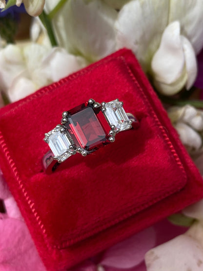 3.50 CTW Emerald Cut Garnet and Moissanite Three Stone Ring in Sterling Silver