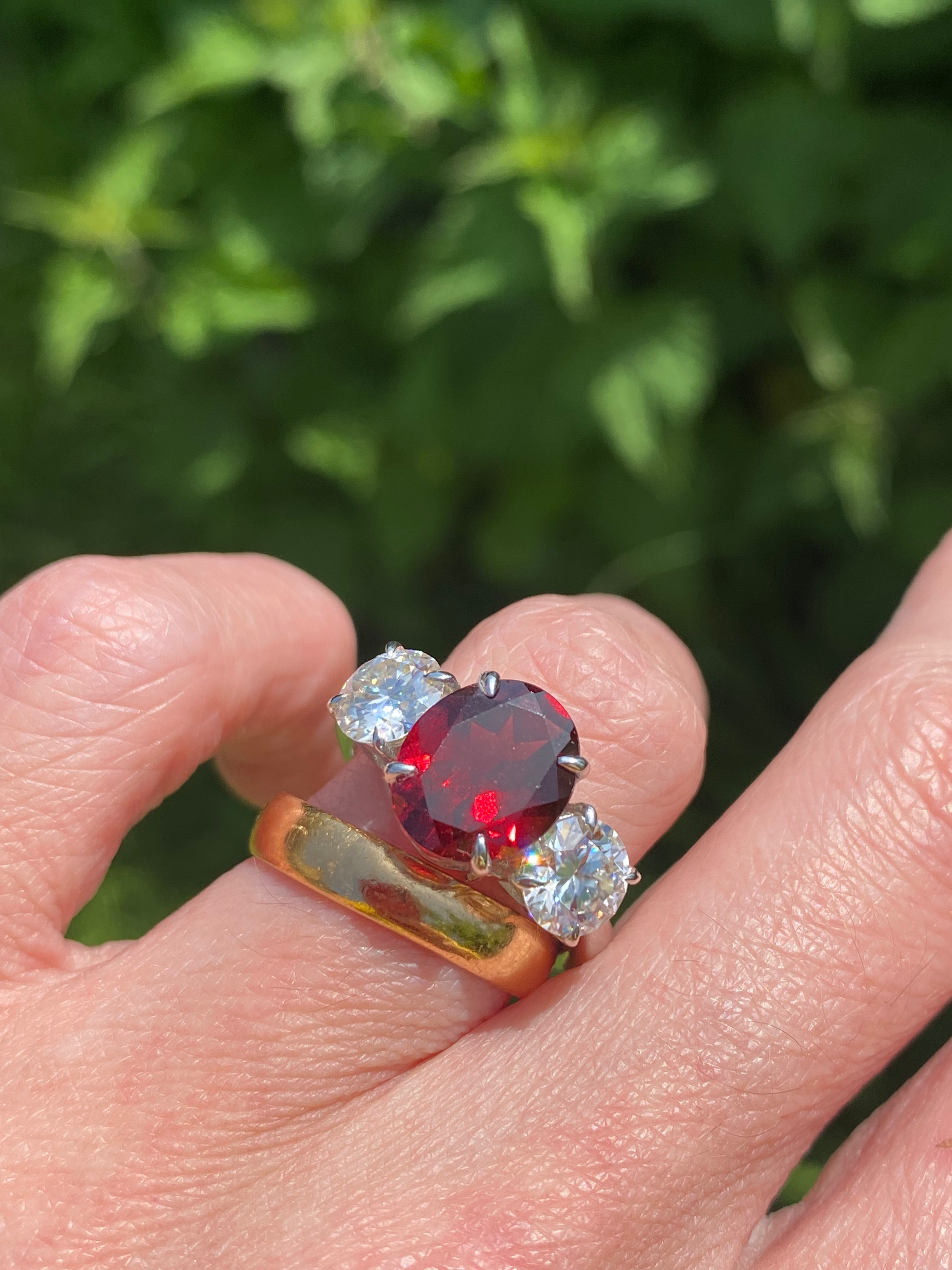 4.10 Carat Oval Cut Garnet and 1.85 Carat Moissanite Three Stone Ring in Sterling Silver