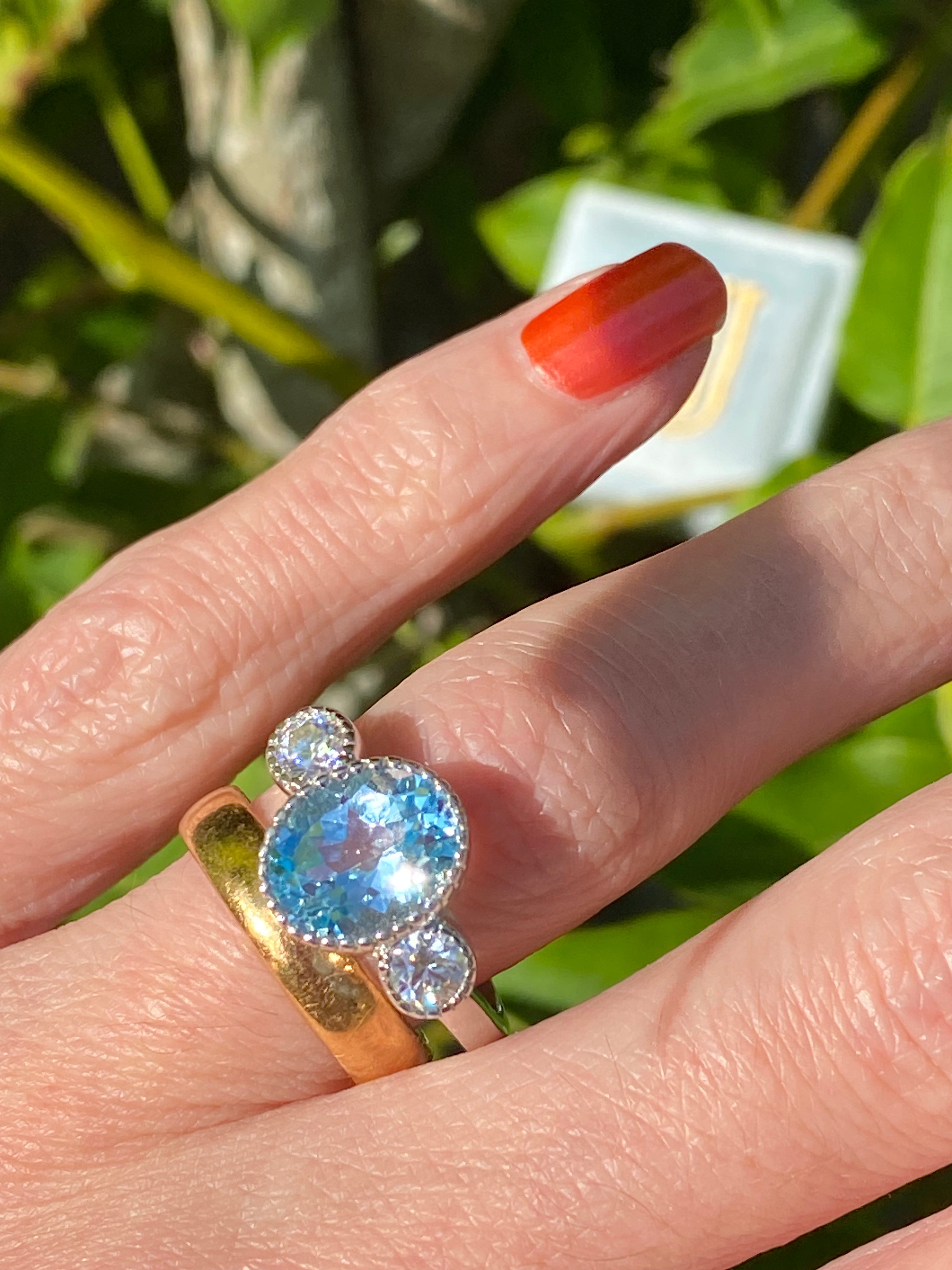 3.34 Carat Oval Cut Blue Topaz and Moissanite Three Stone Ring in Sterling Silver