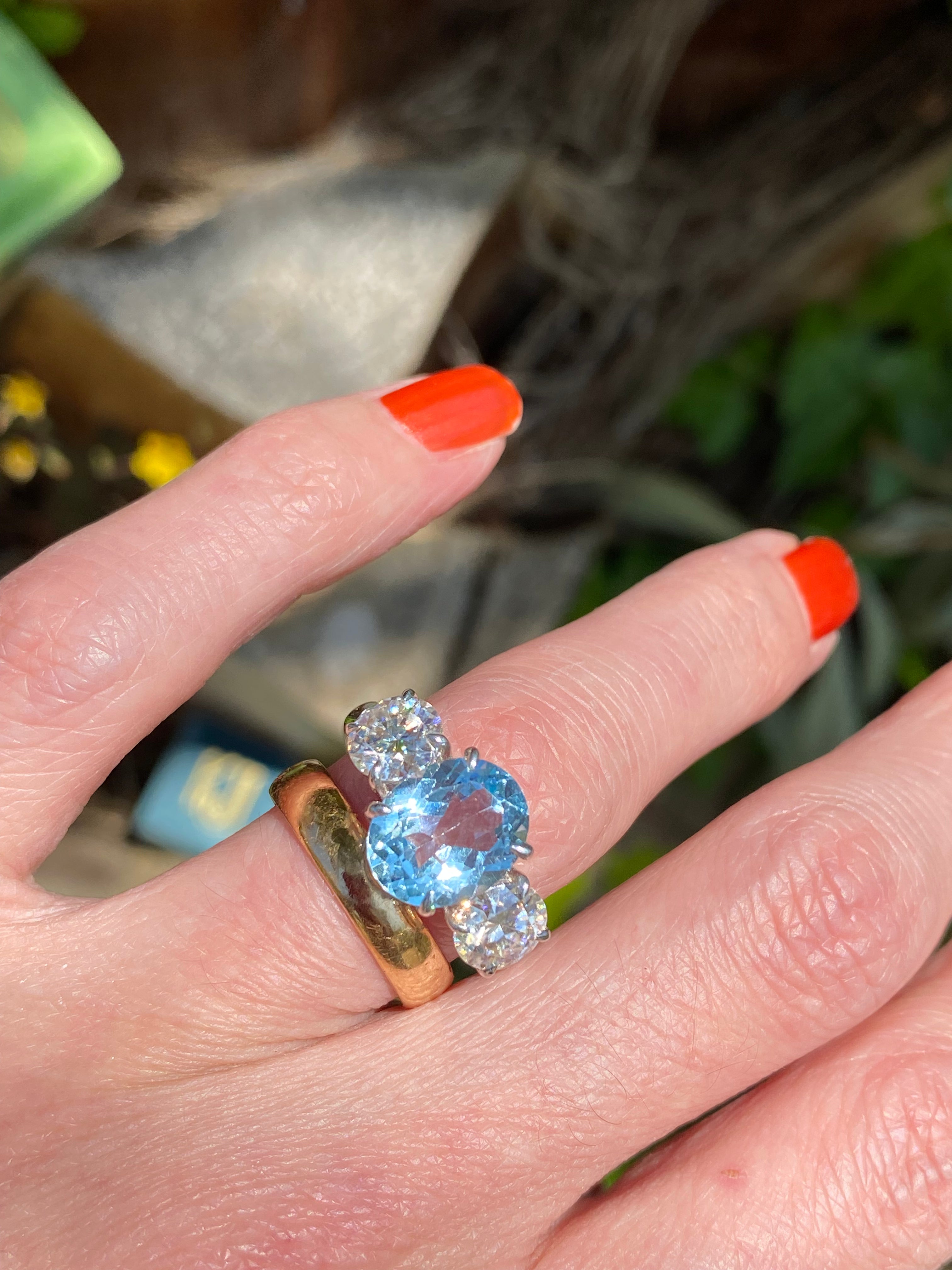 3.99 Carat Oval Cut Blue Topaz and 1.85 Carat Moissanite Three Stone Ring in Sterling Silver