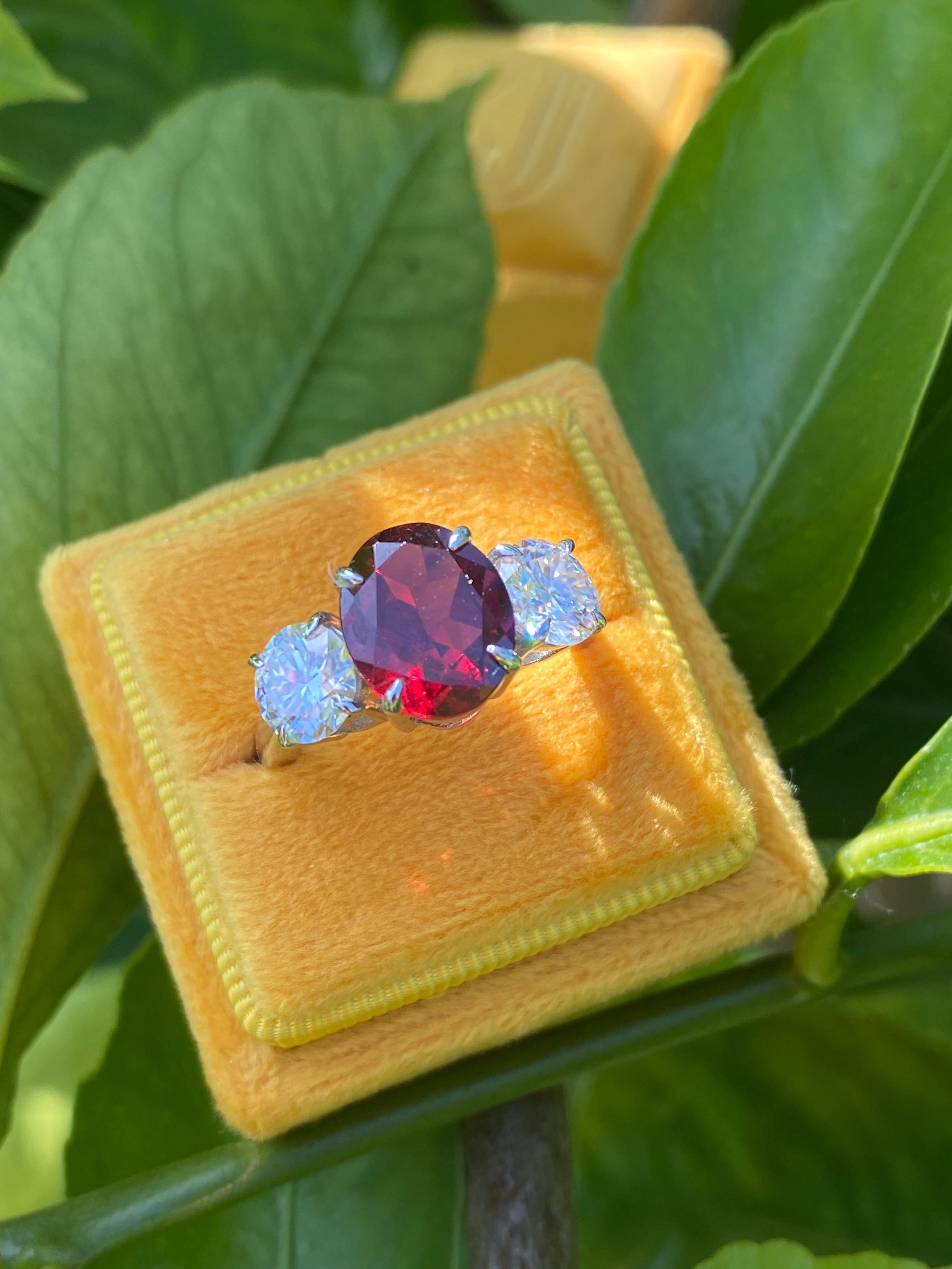 4.10 Carat Oval Cut Garnet and 1.85 Carat Moissanite Three Stone Ring in Sterling Silver