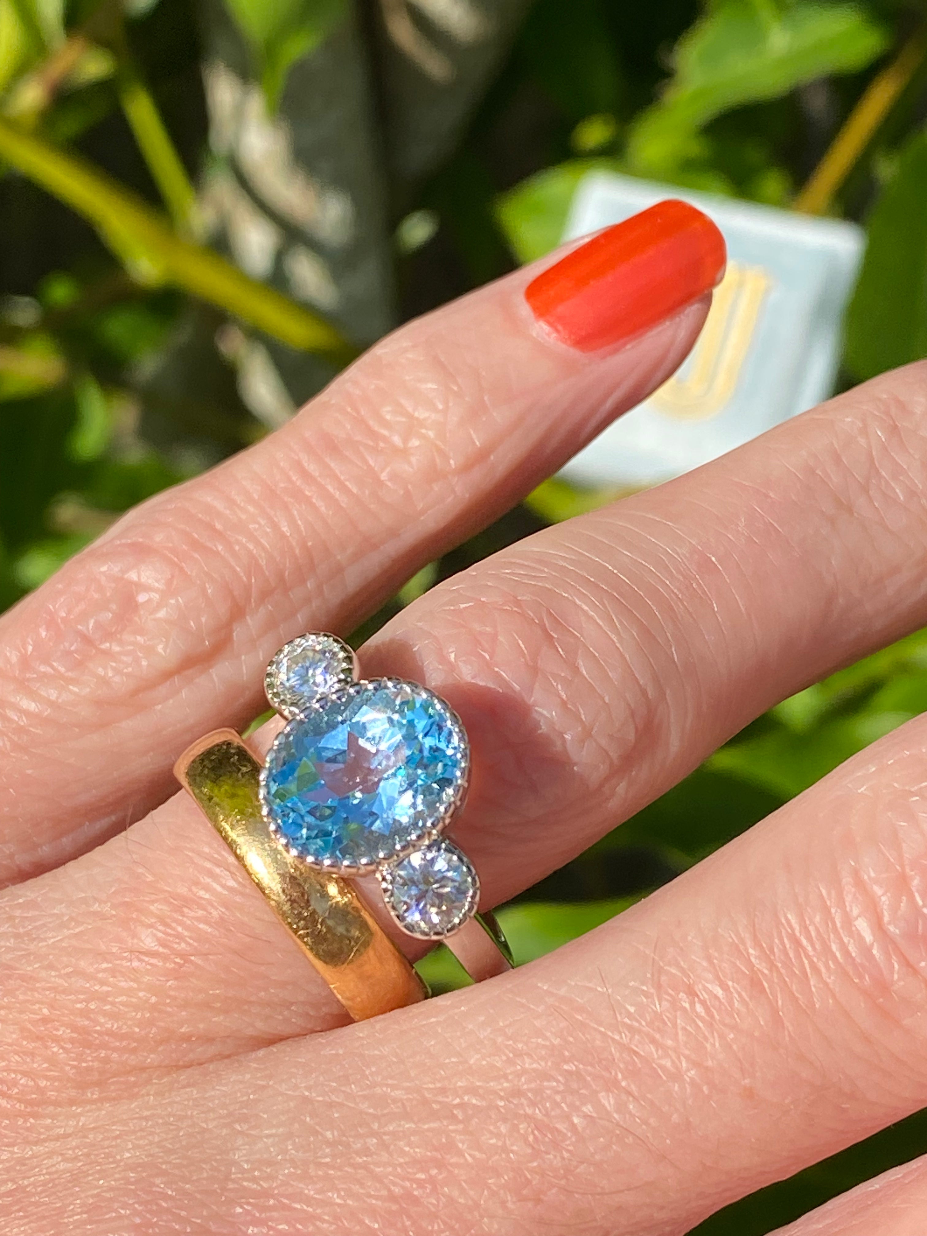 3.34 Carat Oval Cut Blue Topaz and Moissanite Three Stone Ring in Sterling Silver