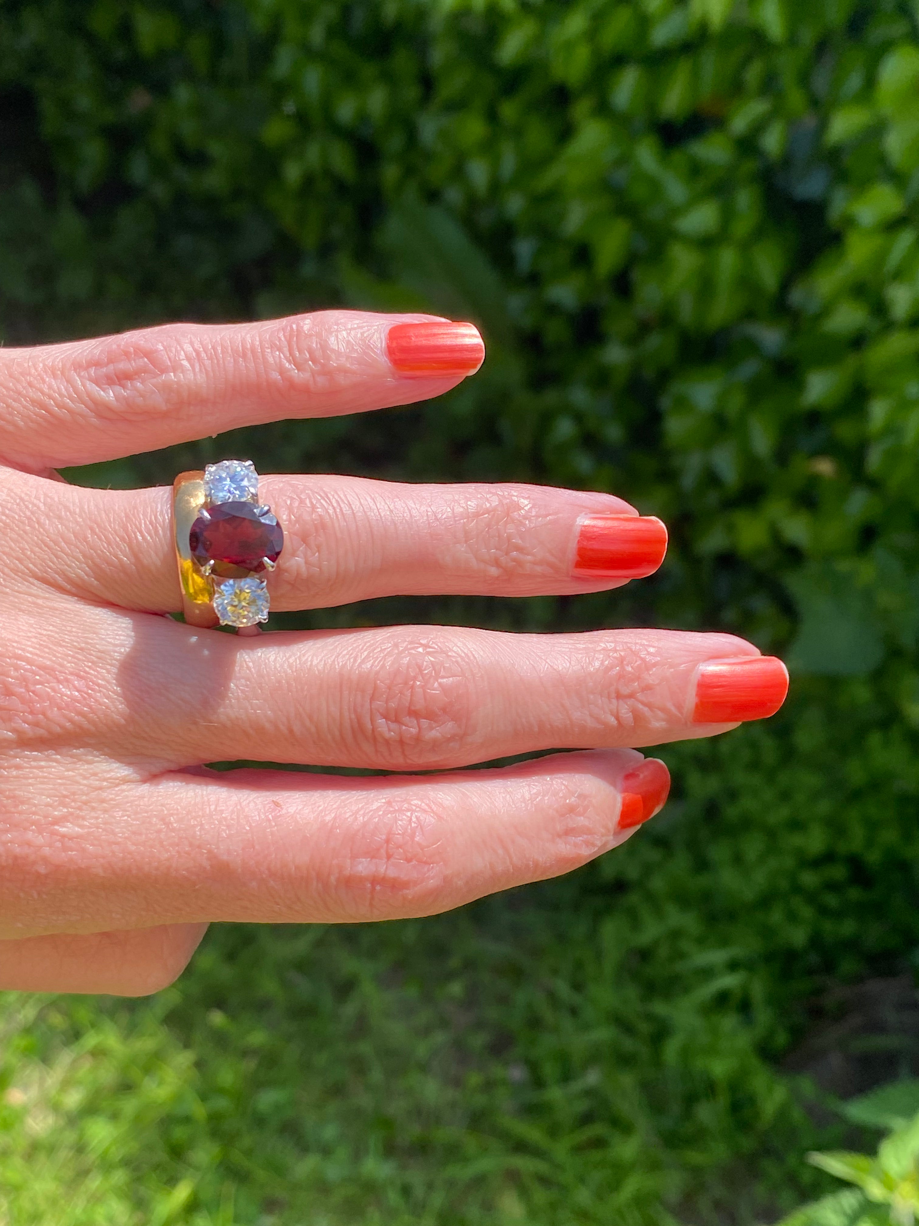 4.10 Carat Oval Cut Garnet and 1.85 Carat Moissanite Three Stone Ring in Sterling Silver