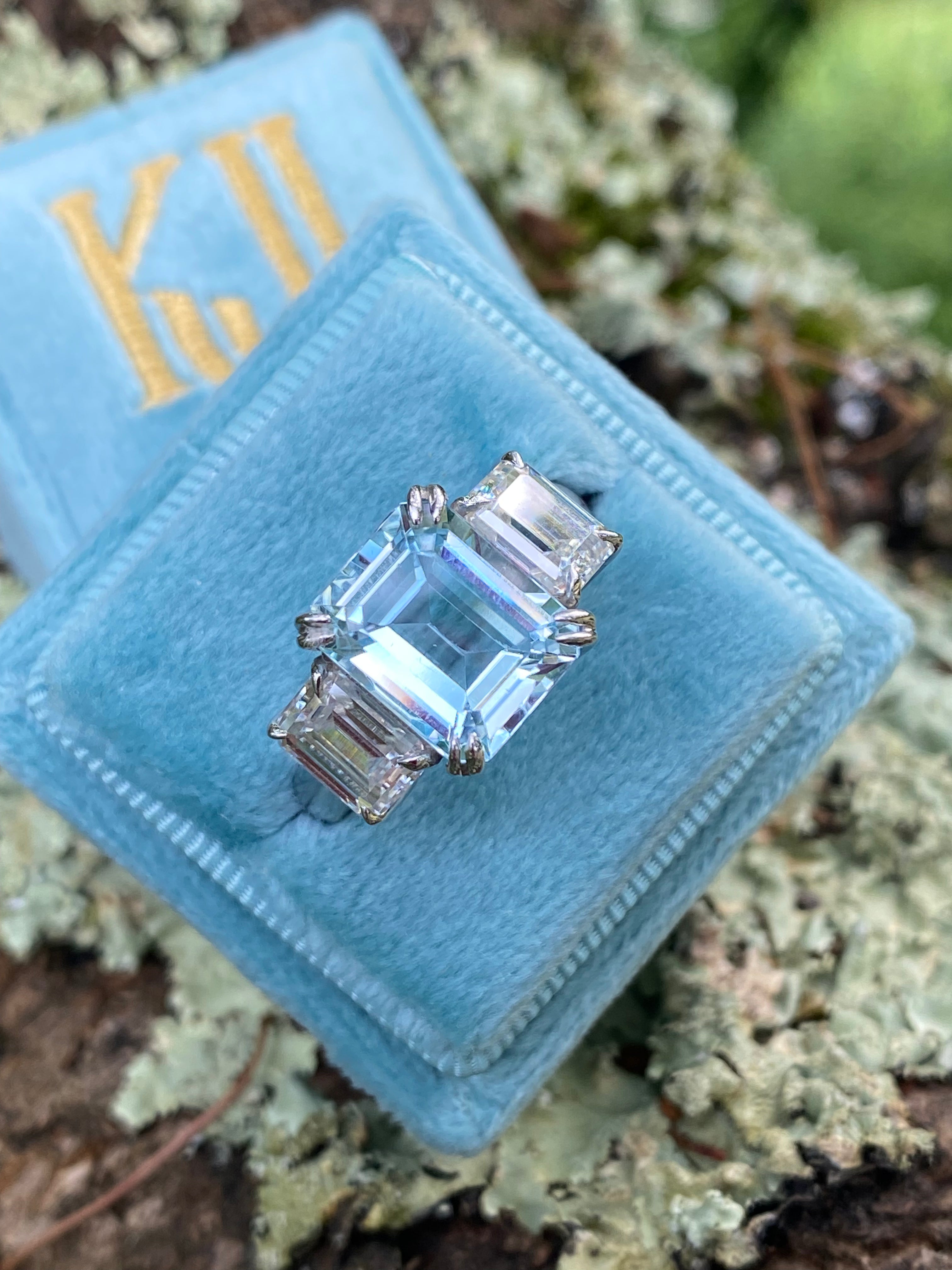 5.71 Carat Emerald Cut Blue Topaz and 2.00 Carat Moissanite Three Stone Ring in Sterling Silver