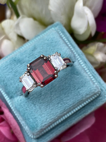 3.50 CTW Emerald Cut Garnet and Moissanite Three Stone Ring in Sterling Silver
