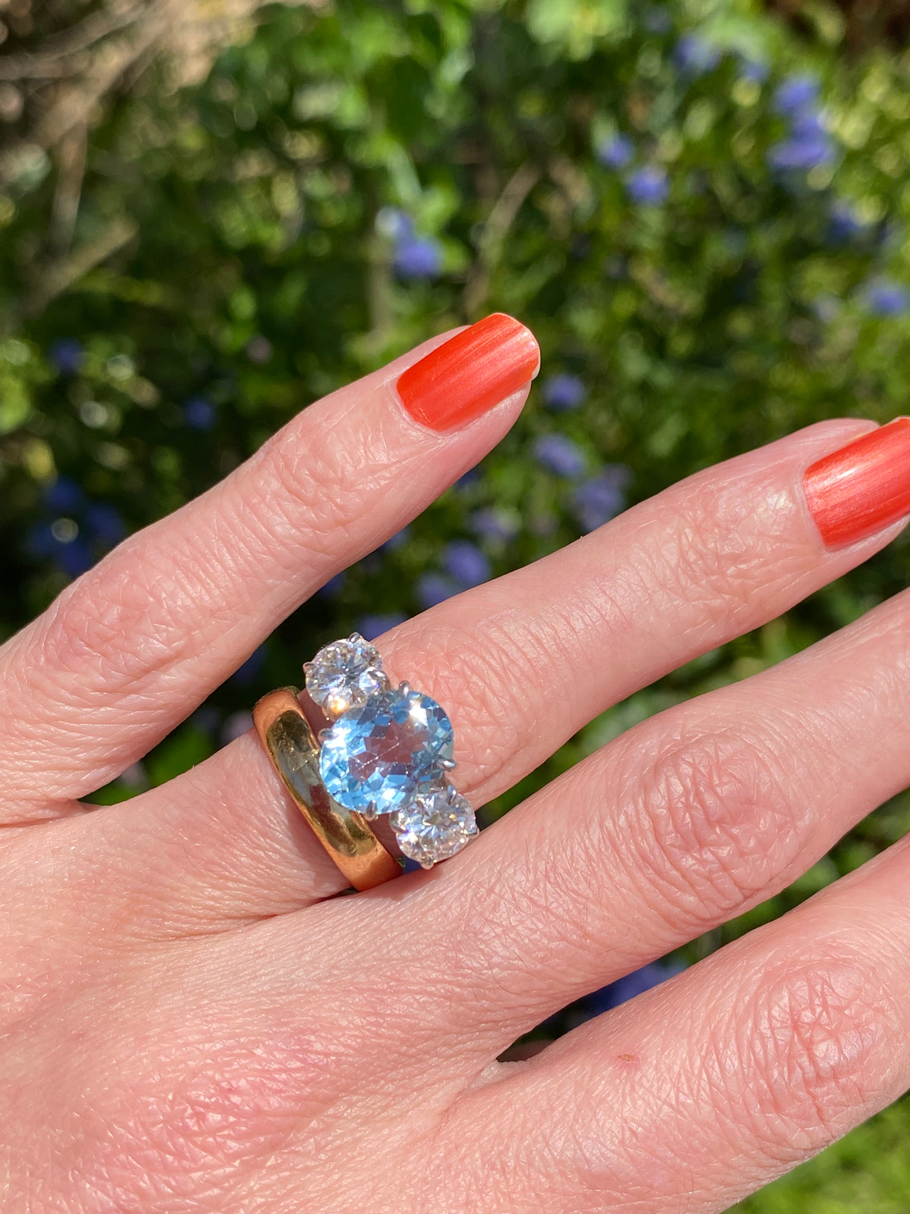 3.99 Carat Oval Cut Blue Topaz and 1.85 Carat Moissanite Three Stone Ring in Sterling Silver