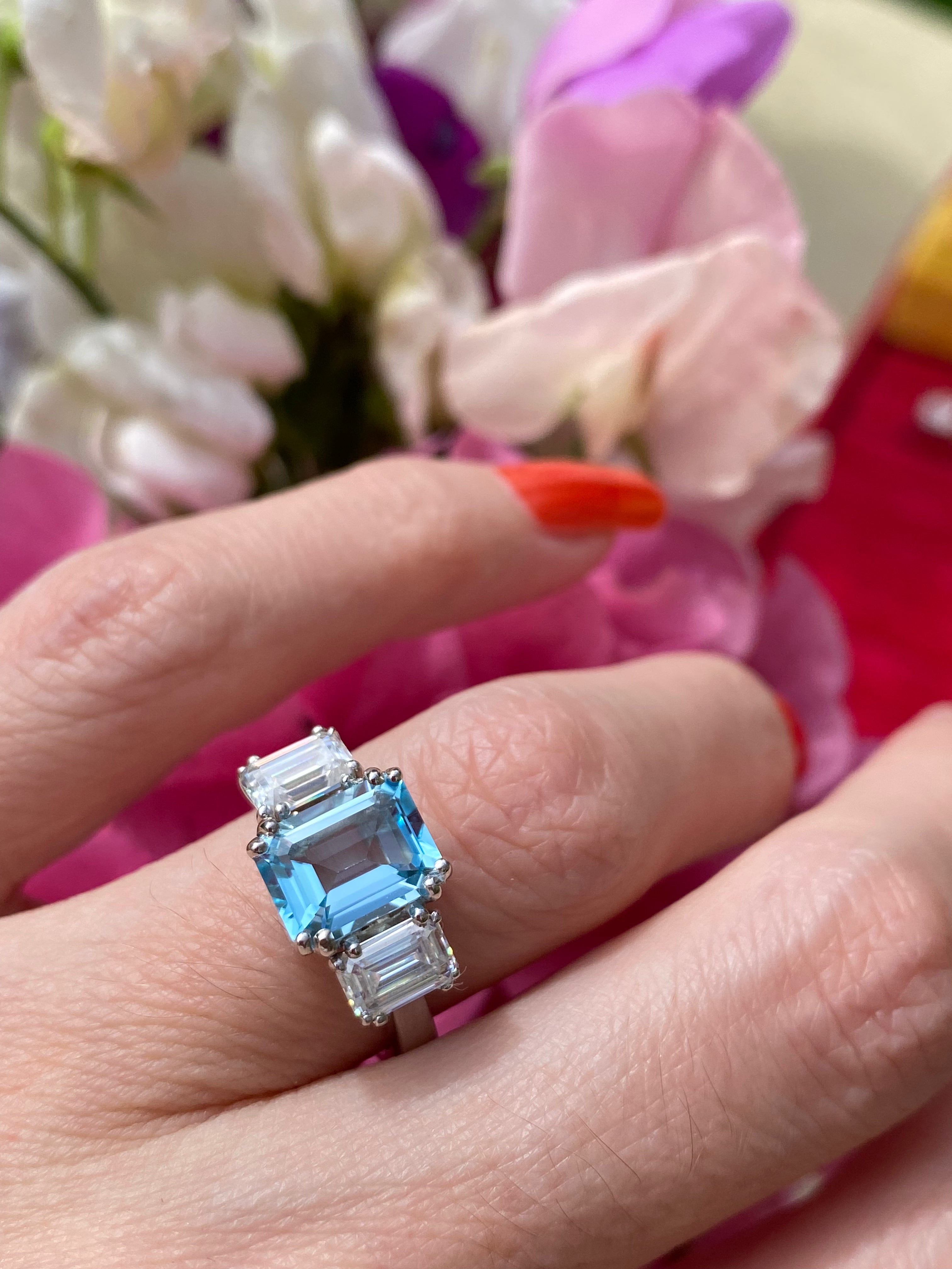 3.50 CTW Emerald Cut Blue Topaz and Moissanite Three Stone Ring in Sterling Silver