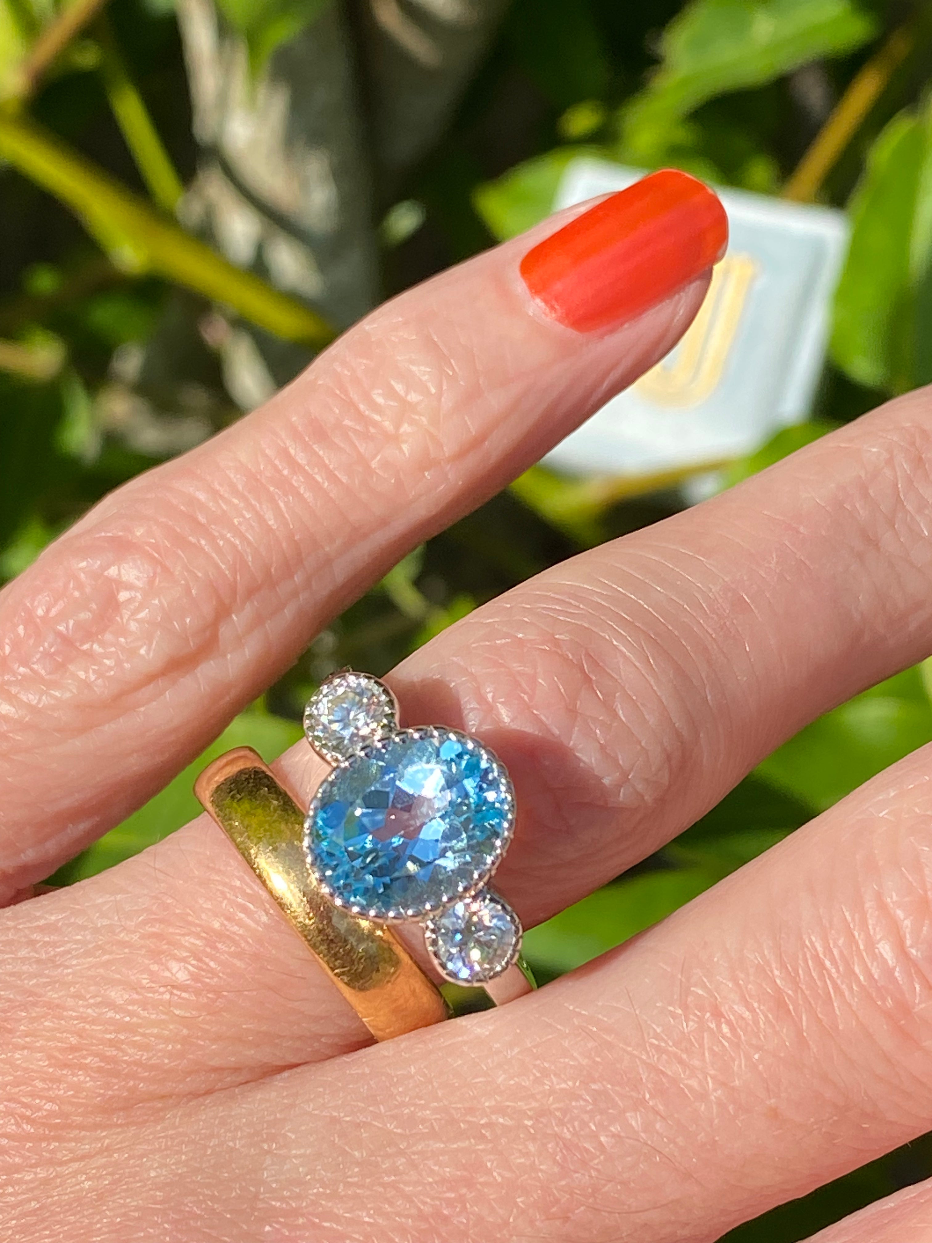 3.34 Carat Oval Cut Blue Topaz and Moissanite Three Stone Ring in Sterling Silver