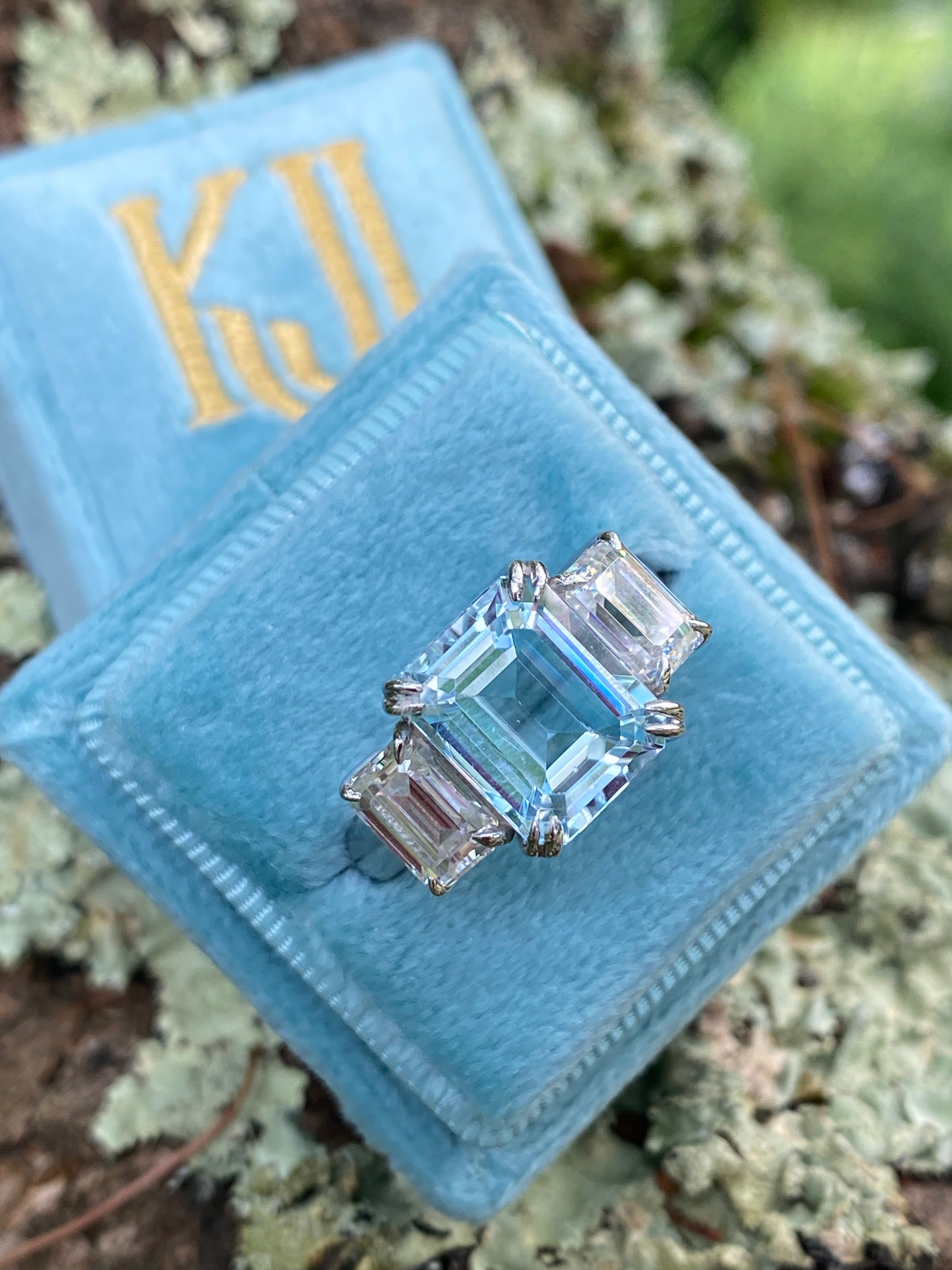 5.71 Carat Emerald Cut Blue Topaz and 2.00 Carat Moissanite Three Stone Ring in Sterling Silver