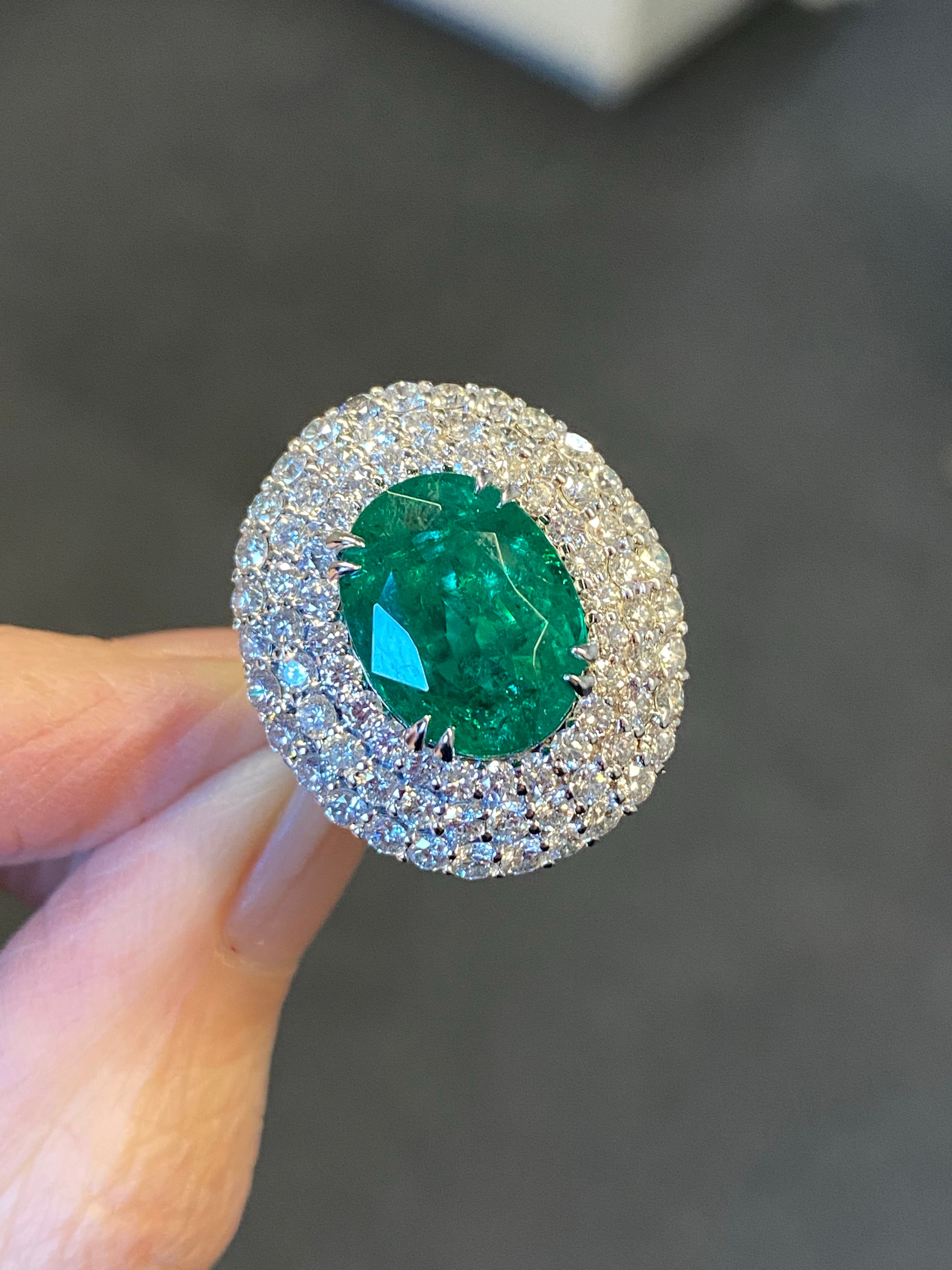 7 Carat Oval Cut Emerald and Triple Diamond Halo Engagement Cocktail Ring in Platinum 